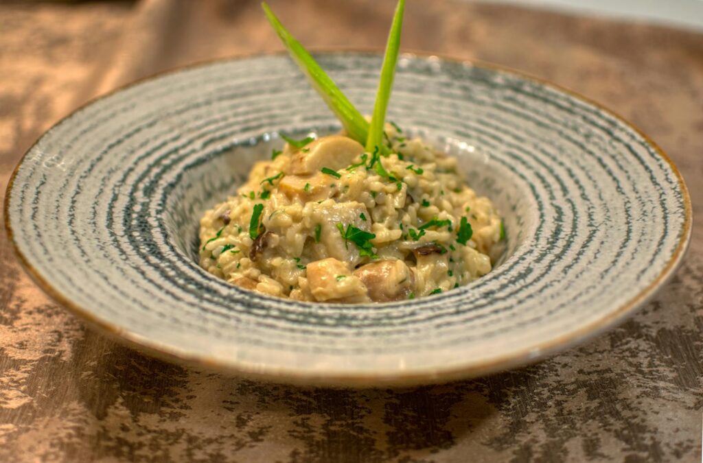 Tantalizing risotto with mushrooms and parsley served in a stylish dish.