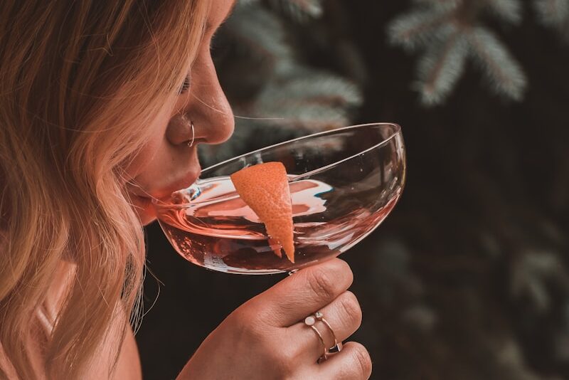 woman holding cocktail glass