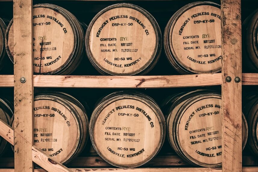 a shelf filled with lots of wooden barrels