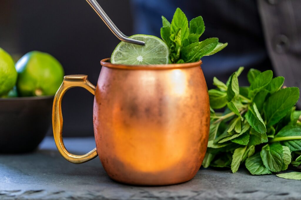 brass-colored mug with sliced lime